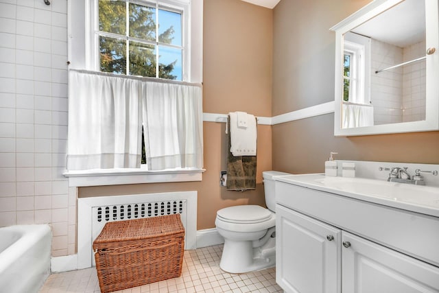 full bathroom with baseboards, toilet, radiator, tile patterned flooring, and vanity