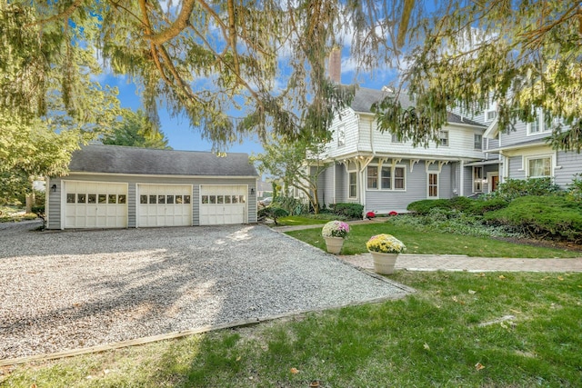 view of front facade with a front yard and gravel driveway