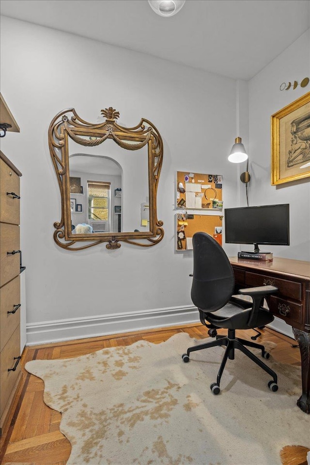 home office with wood finished floors and baseboards