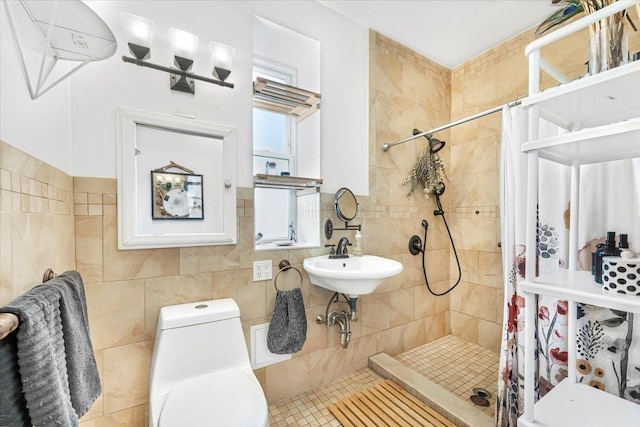 full bath featuring a sink, a shower stall, toilet, and tile walls