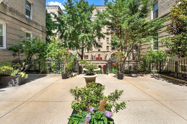 view of community with fence and a patio