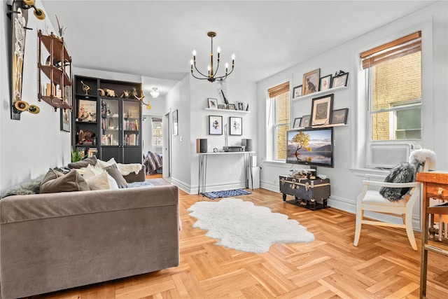 living room with an inviting chandelier and baseboards