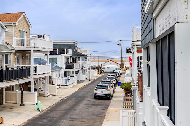 view of street featuring curbs, sidewalks, and street lights