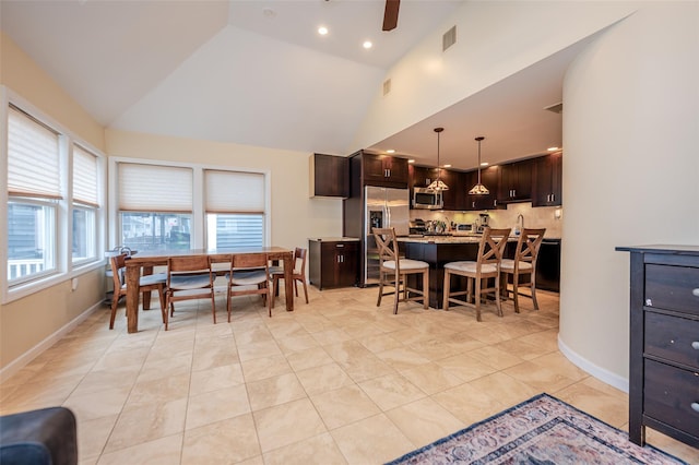 dining space with high vaulted ceiling, baseboards, light tile patterned floors, and visible vents