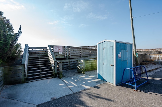 view of gate featuring a shed and an outbuilding