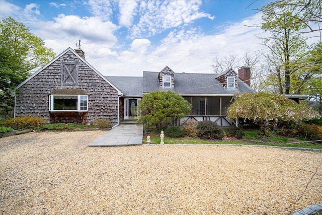 view of front of house featuring a chimney