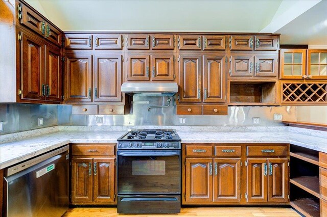 kitchen with stainless steel dishwasher, open shelves, under cabinet range hood, and black gas stove