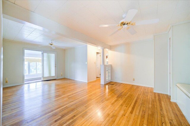 empty room with ornamental molding and ceiling fan