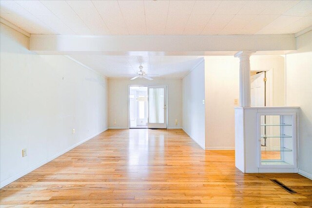 spare room with crown molding, a ceiling fan, light wood-style flooring, and visible vents