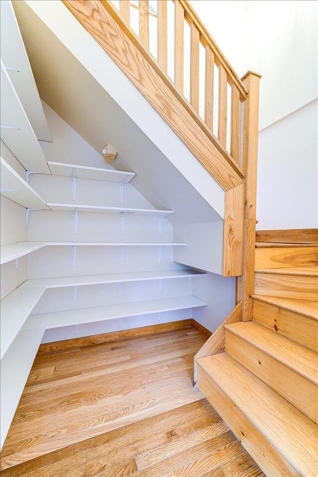stairway with wood finished floors