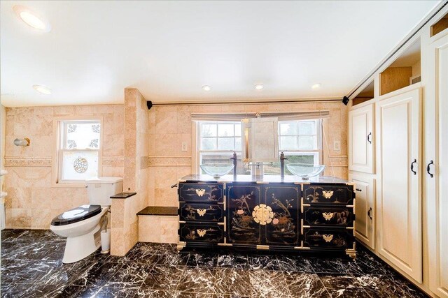 interior space with recessed lighting, a sink, and marble finish floor