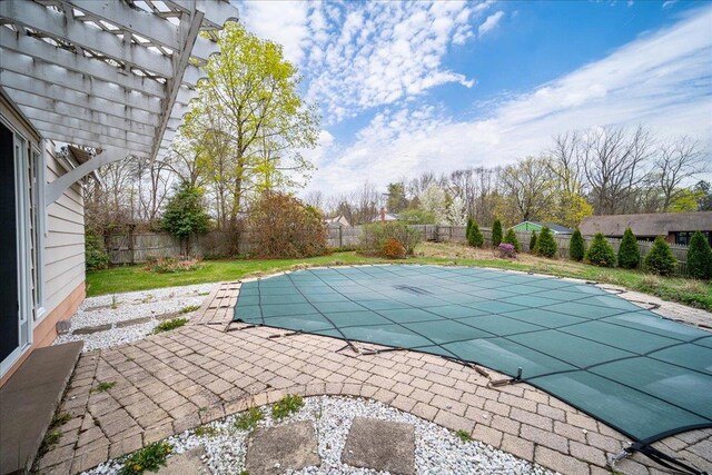 view of swimming pool with a fenced in pool, a fenced backyard, a pergola, and a patio
