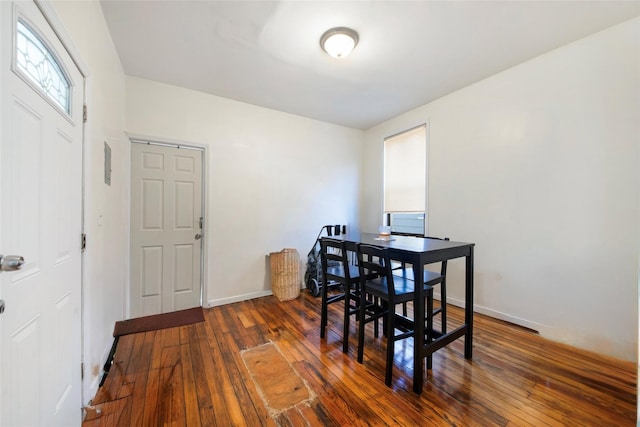 dining room with a healthy amount of sunlight, baseboards, and hardwood / wood-style floors