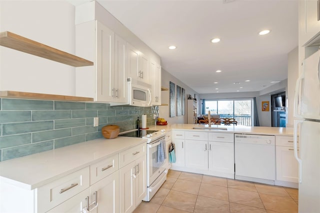 kitchen featuring white appliances, light tile patterned floors, decorative backsplash, open shelves, and a sink