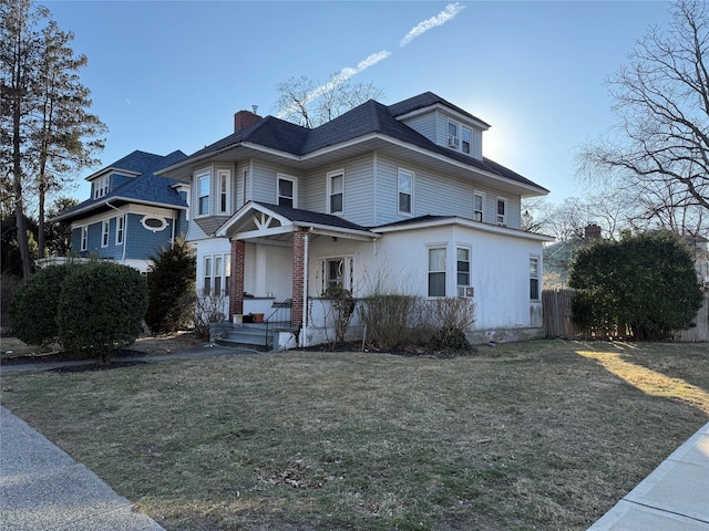 view of front of home with a front lawn and fence