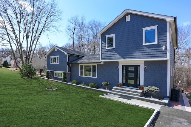 tri-level home with a front yard