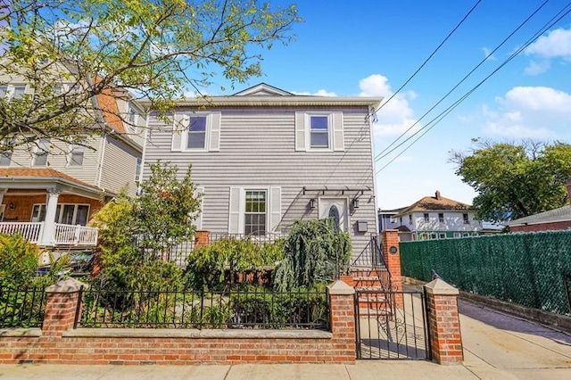 view of front of house with a fenced front yard and a gate