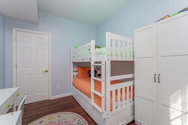 bedroom featuring wood finished floors and baseboards