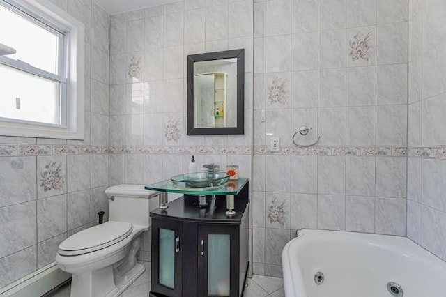 full bath featuring toilet, a baseboard heating unit, vanity, tile walls, and a tub with jets