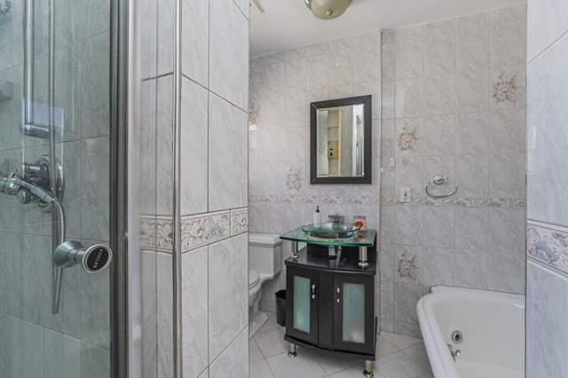 full bathroom featuring a whirlpool tub, tile patterned flooring, a shower stall, and tile walls