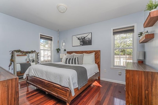 bedroom featuring dark wood-style flooring and baseboards