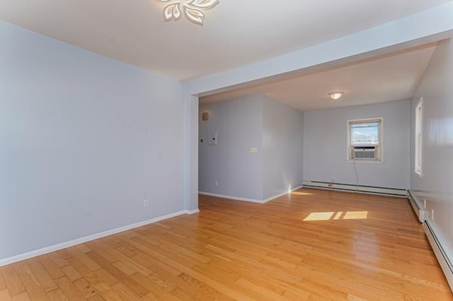 unfurnished room featuring baseboards, a baseboard radiator, cooling unit, light wood-style floors, and a baseboard heating unit