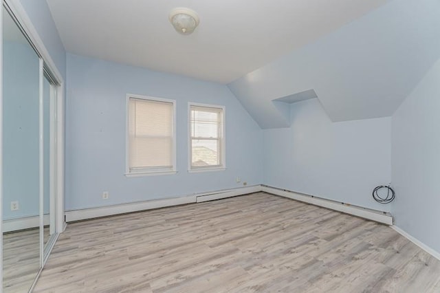 bonus room with lofted ceiling and wood finished floors