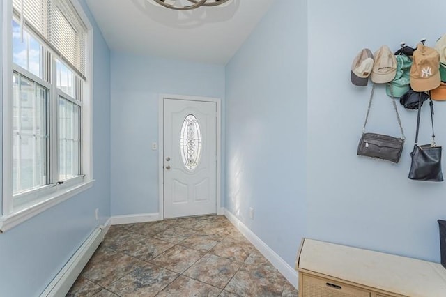 entrance foyer with a baseboard radiator, a healthy amount of sunlight, and baseboards