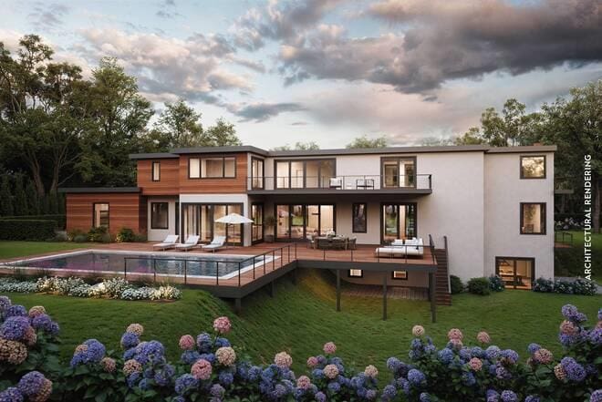 rear view of house with a patio, a balcony, a lawn, an outdoor pool, and stucco siding