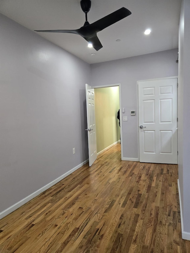 unfurnished bedroom featuring ceiling fan, baseboards, wood finished floors, and recessed lighting