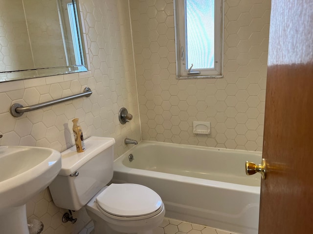 full bath with tasteful backsplash, tile walls, toilet, tile patterned floors, and a sink