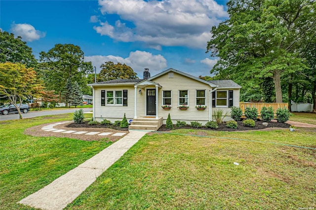 view of front of home featuring a front yard and a chimney