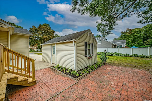 view of outbuilding featuring an outbuilding and fence