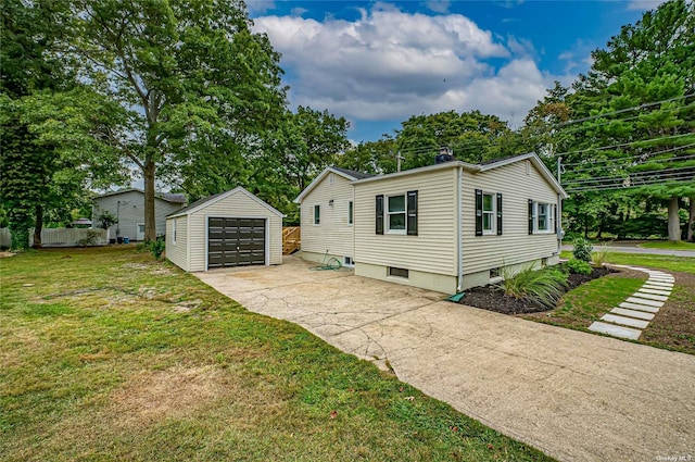 view of home's exterior featuring a garage, a yard, concrete driveway, and an outdoor structure