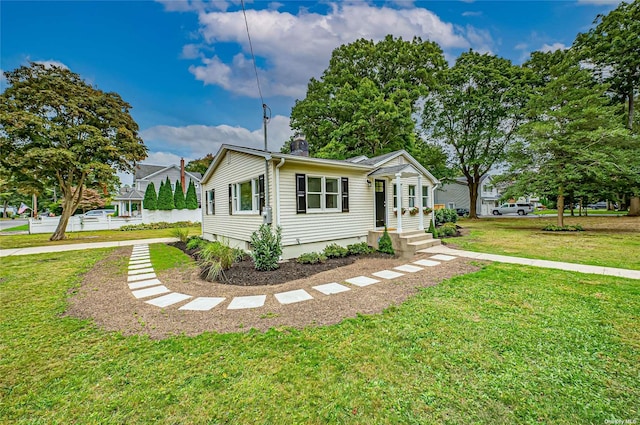 view of front of house with a chimney and a front yard