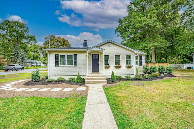 view of front of property with a chimney and a front yard