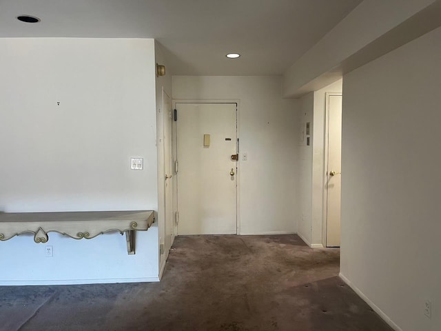 interior space with baseboards and recessed lighting