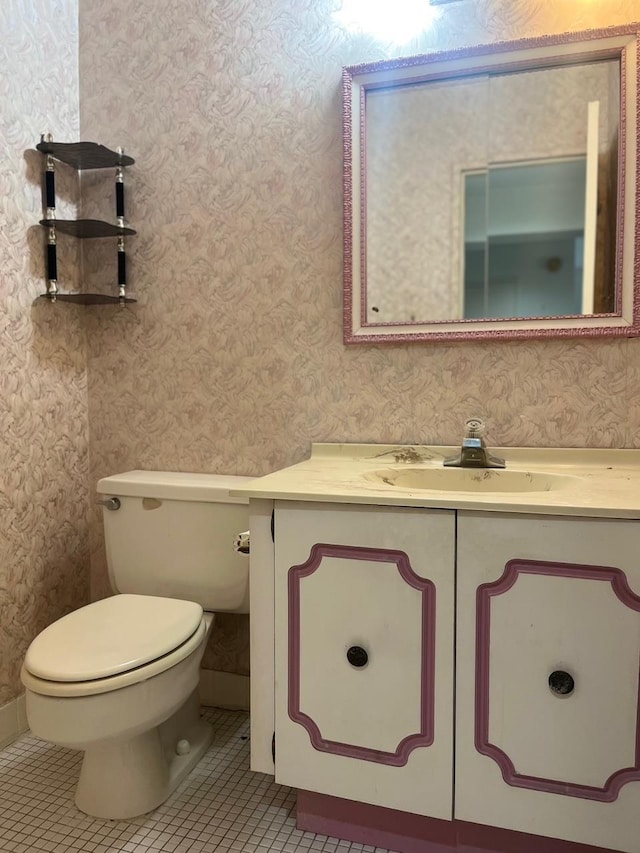 bathroom featuring vanity, tile patterned floors, toilet, and wallpapered walls