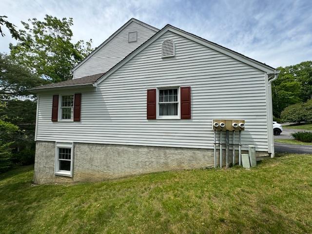 view of side of home featuring a yard