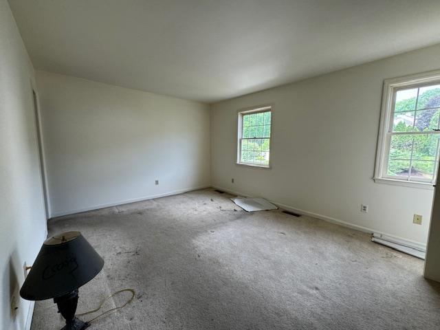 unfurnished room featuring visible vents