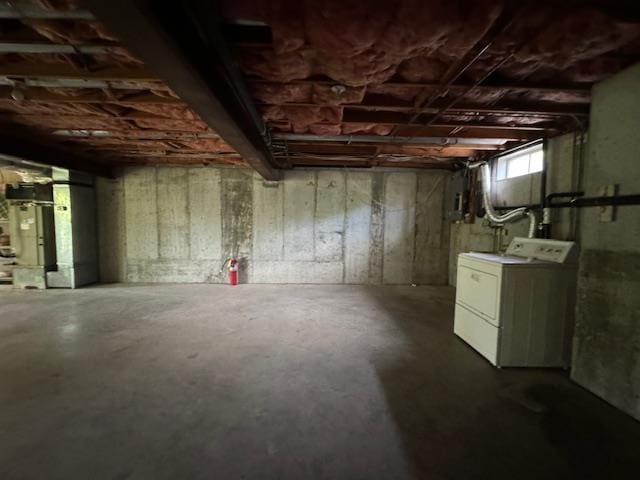 below grade area with washer / clothes dryer and heating unit