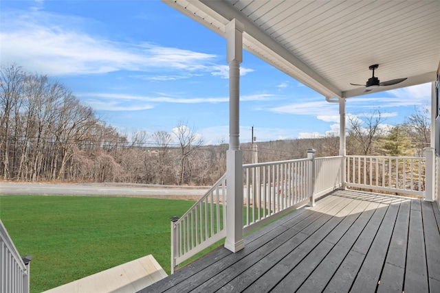 deck with ceiling fan and a lawn