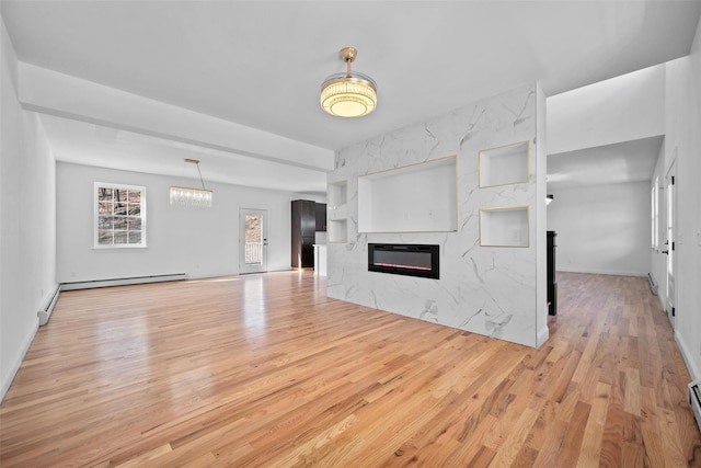 unfurnished living room with a fireplace, a baseboard heating unit, and wood finished floors