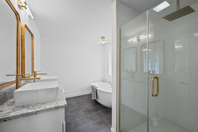 full bath featuring double vanity, a stall shower, baseboards, a soaking tub, and a sink