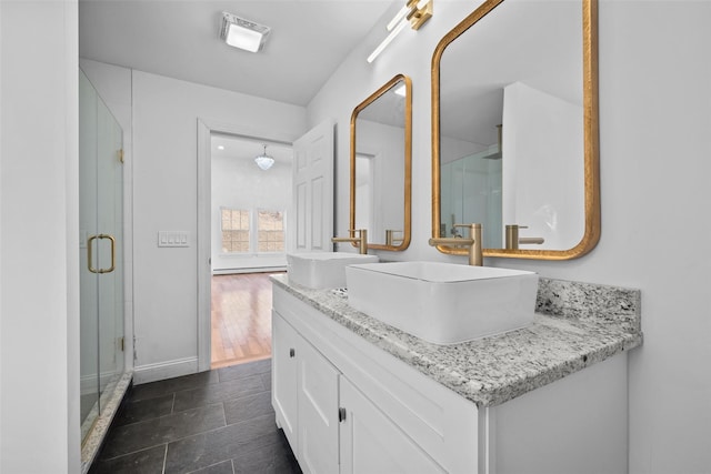 full bath featuring double vanity, a stall shower, a sink, and visible vents