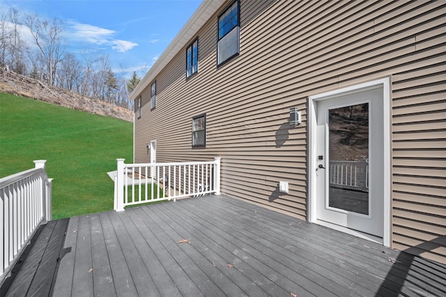 wooden terrace featuring a yard