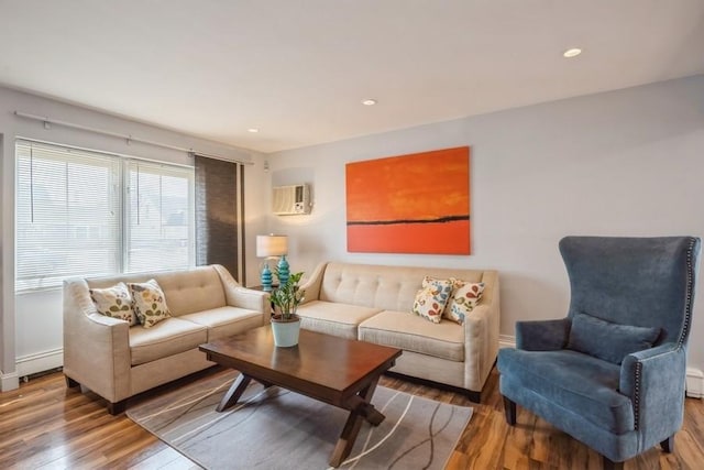 living area featuring recessed lighting, baseboards, wood finished floors, and a wall mounted AC