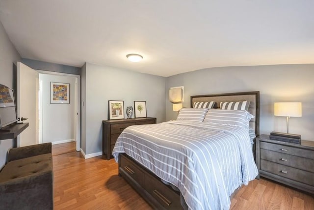 bedroom with light wood-style flooring and baseboards