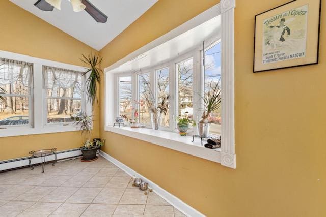 workout room with lofted ceiling, a baseboard radiator, ceiling fan, baseboards, and tile patterned floors