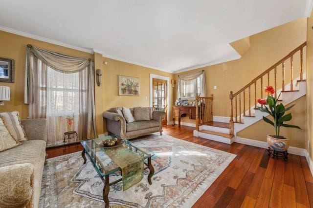 living room with ornamental molding, wood finished floors, baseboards, and stairs